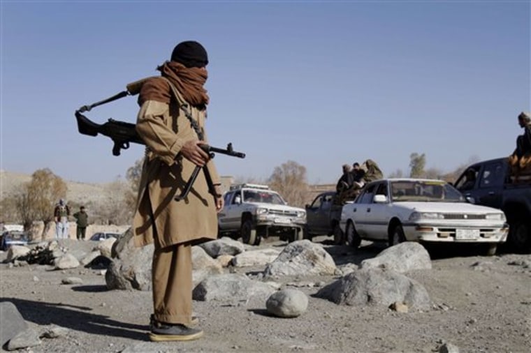 A Taliban fighter mans a checkpoint in Nangarhar province, Afghanistan on Dec. 13, 2010. Apart from a resilient Taliban insurgency, Afghanistan is also plagued by a dizzying and increasing array of armed groups, from militant fighters to criminal gangs, drug traffickers and militias.